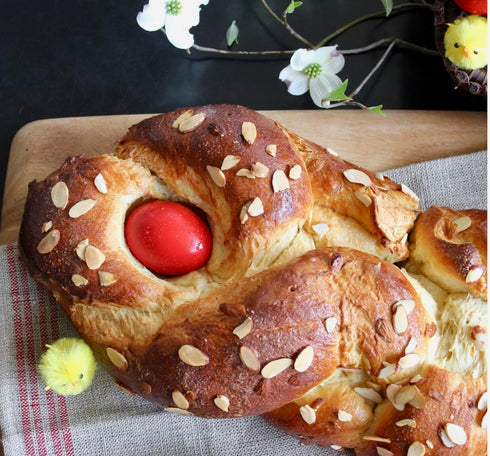 Generic Tsoureki Greek Easter Braided Bread with Red Egg, Topped with Sliced Almonds